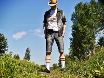 Man standing by plants against sky