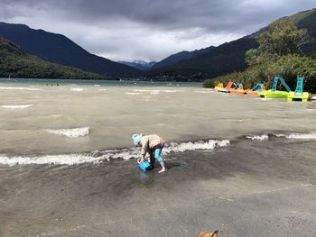 People on beach against sky