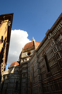 Low angle view of buildings against sky in city