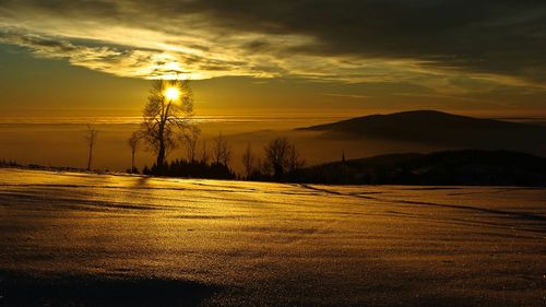 Scenic view of landscape against sky during sunset