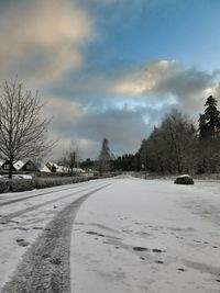 Road passing through snow covered landscape