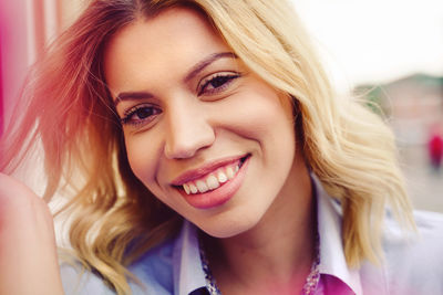 Close-up portrait of smiling young woman