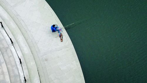 High angle view of man fishing in river