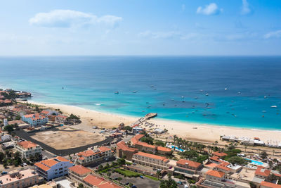 High angle view of sea and buildings against sky