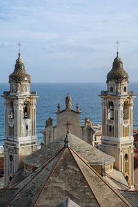 Top of the church of san matteo against sea and sky, laigueglia, savona, liguria, italy