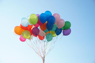 Low angle view of balloons against sky