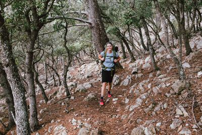 Man running on footpath in forest