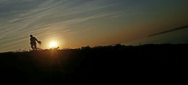 Scenic view of silhouette field against sky at night