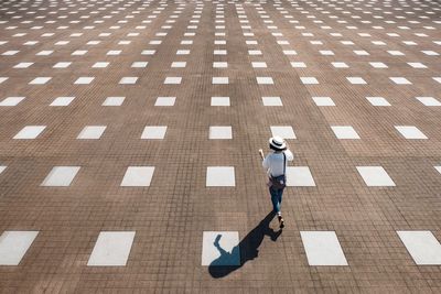 High angle view of woman walking on footpath