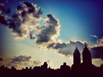 Silhouette of building against cloudy sky