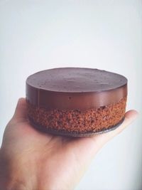 Close-up of cropped hands over white background