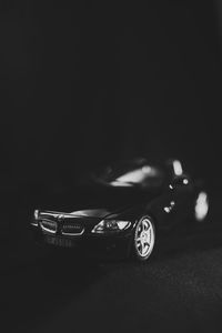 Close-up of toy car on table against black background