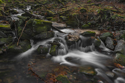 Stream flowing through rocks in forest