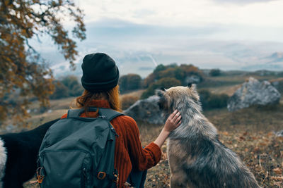 Rear view of man with dog