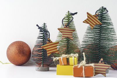 Christmas decorations on table against white background