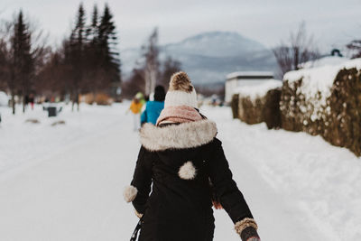 Rear view of person on snow covered mountain