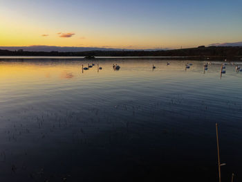 Scenic view of lake at sunset