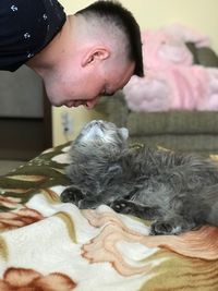 Midsection of man with dog at home