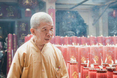 Man looking away while standing in temple
