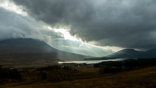 Scenic view of mountains against cloudy sky