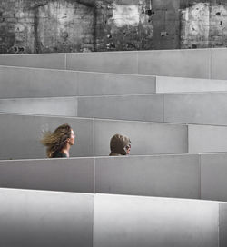 Female friends walking amidst railings