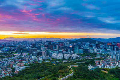 High angle view of buildings against sky during sunset