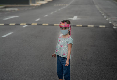 Child wearing face shield outdoor during coronavirus epidemic. new normal lifestyle, public places.