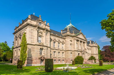 Low angle view of historical building against blue sky