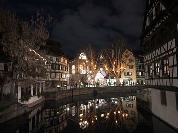 Reflection of illuminated buildings in canal at night