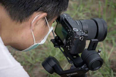 Close-up portrait of man photographing camera