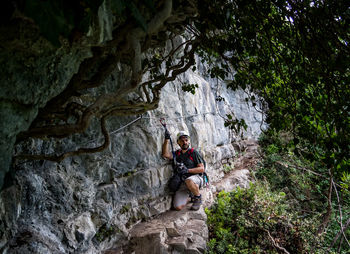 Mature man climbing on mountain