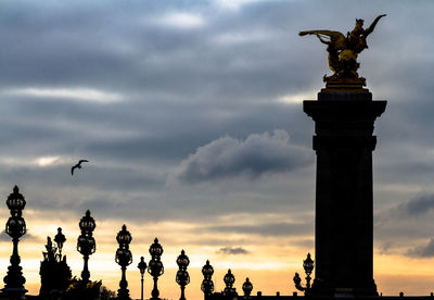 Low angle view of statue against cloudy sky