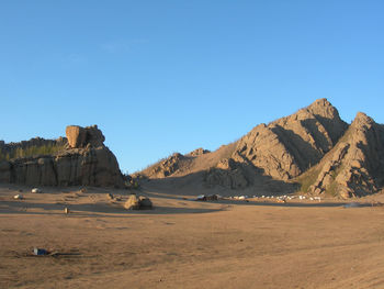 Scenic view of desert against clear blue sky