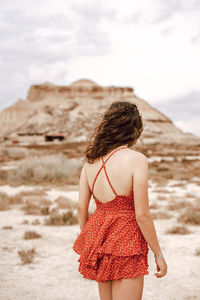 Rear view of woman looking at camera