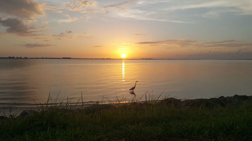 Scenic view of lake against sky during sunset