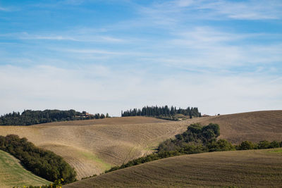 Scenic view of farm against sky