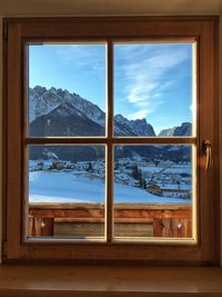 Snow covered landscape seen through window