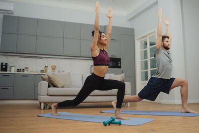 Full length of woman exercising in gym