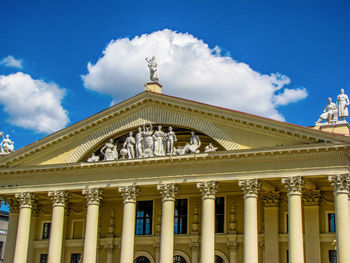 Low angle view of building against cloudy sky