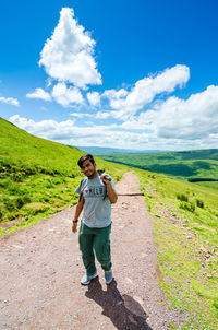 Full length of man standing on field against sky