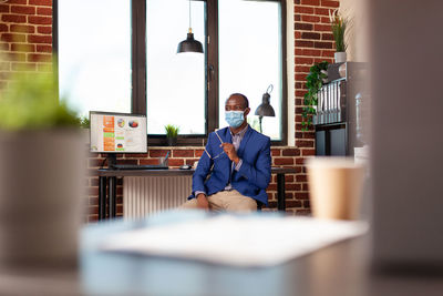 Businessman sitting in office during pandemic