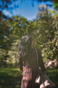 Person walking through a park in the spring.