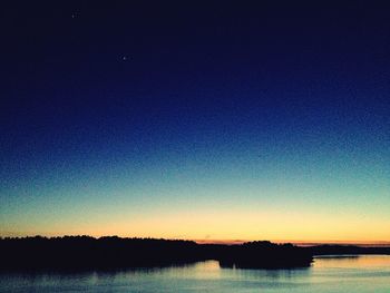 Scenic view of silhouette trees against sky at night