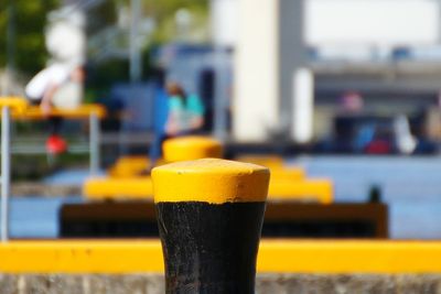 Close-up of bollards in river