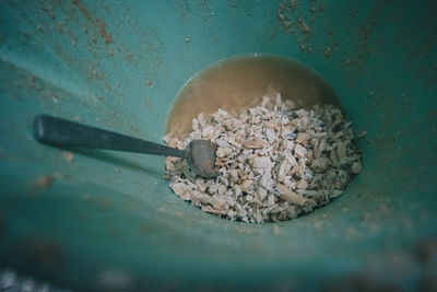 High angle view of carbonate mineral with spoon in container