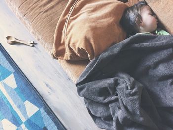 High angle view of boy sleeping on bed at home