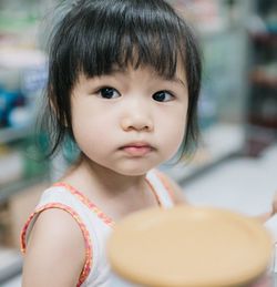 Close-up of cute girl in supermarket