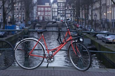 Bicycles parked on street against buildings in city