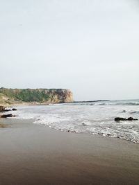 Scenic view of beach against clear sky