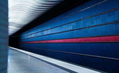 Blue patterned wall at subway station